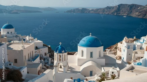 Scenic view of white buildings with blue domes overlooking the sea in Santorini, Greece