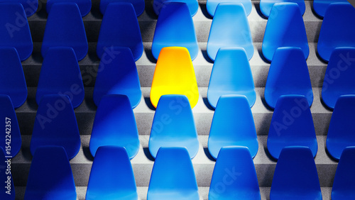 Bright yellow stadium seat stands out among blue chairs in isolation