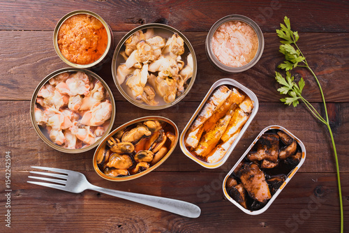 Canned seafood assortment displayed on wooden table