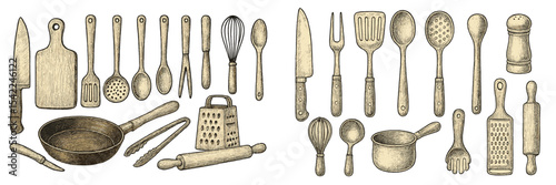 Collection of traditional kitchen utensils and tools displayed on a wooden background