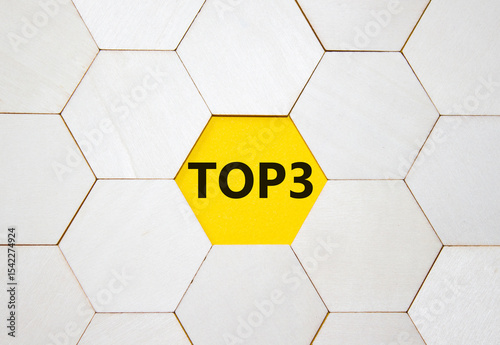 Top 3 symbol. Concept word Top 3 on wooden comb puzzle. Beautiful yellow background. Business and Top 3 concept. Copy space. photo