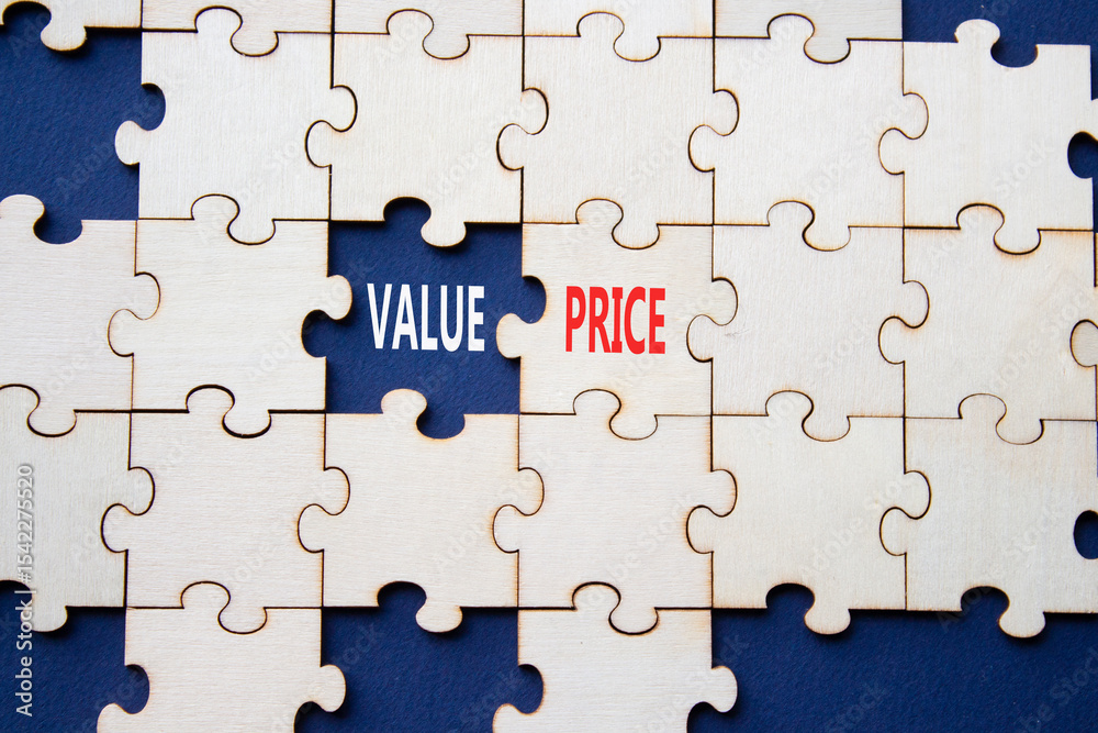 Fototapeta premium Price and Value symbol. Concept word Price and Value on wooden puzzle. Beautiful deep blue background. Business and Price and Value concept. Copy space