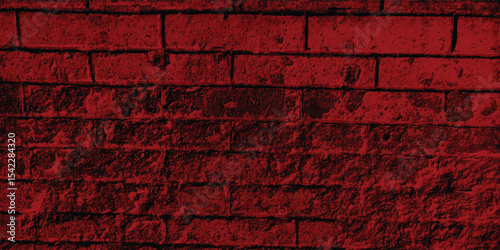 Red-scale image of a building exterior, highlighting intricate patterns and shadows cast on its textured walls.
