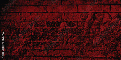 Close-up of a decorative concrete block wall in a deep red, highlighting its geometric pattern and textural depth within the shadows.
