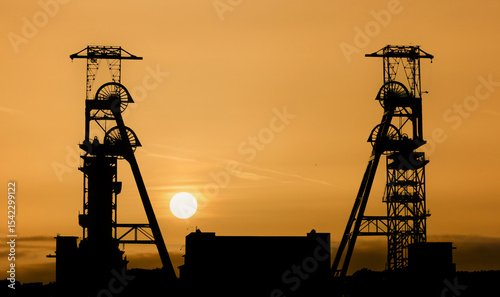 Bild auf Leinwand Coal Mine headstocks at sunset