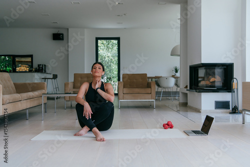 Woman Relaxing After Home Workout in a Modern Living Room