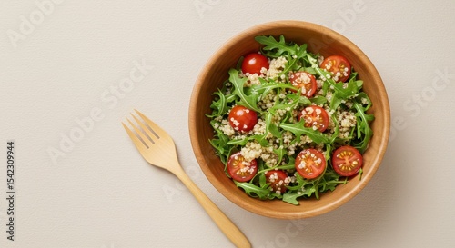 Healthy Salad with Tomatoes and Greens in Wooden Bowl