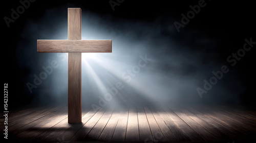 A wooden cross in the spotlight on a black background, symbolizing faith, sacrifice, and hope in a dramatic and solemn setting.
