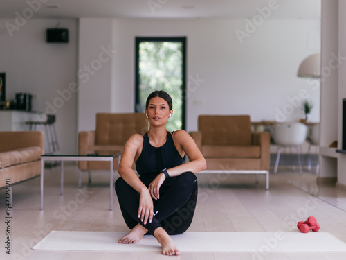 Young Beautiful Female Exercising, Stretching and Practising Yoga with Trainer via Video Call Conference in Bright Sunny House. Healthy Lifestyle, Wellbeing and Mindfulness Concept