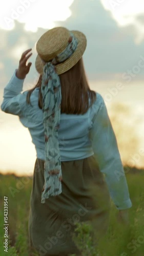 A woman enjoys a serene day in a picturesque field, embracing nature