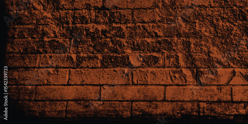 Rustic block wall illuminated by a warm, subdued light, revealing its intricate structure and time-worn imperfections with a dark fade.
