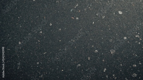 dark colored recycled plastic with visible specks of colorful fragments
