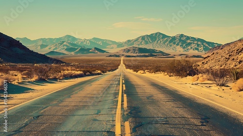 A long, paved road stretches into a vast desert landscape.