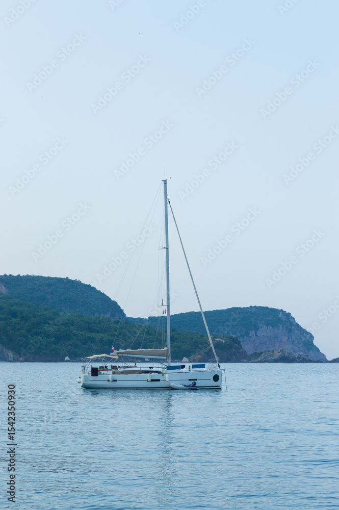 Yachting on a serene seascape at sea. A lone ship sailing on the water on a sunny summer day. Frontal view Yachting on a serene seascape at sea. A lone ship sailing on the water on a sunny summer day. Frontal view