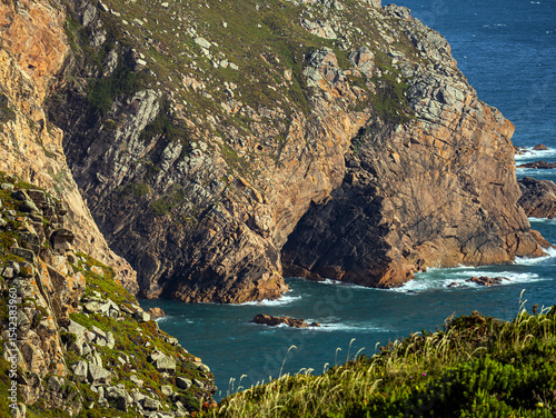 Fototapeta Naklejka Na Ścianę i Meble -  Rocks and greenery at Cabo da Roca, Sintra, Portugal on the Atlantic Ocean	
