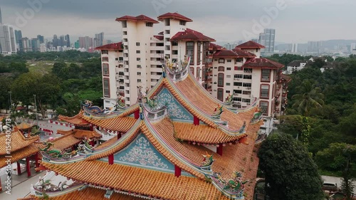 Traditional chinese temple roof architectural elements featuring ornate dragon sculptures, hanging lanterns, intricate wood carvings at kek lok si temple, penang