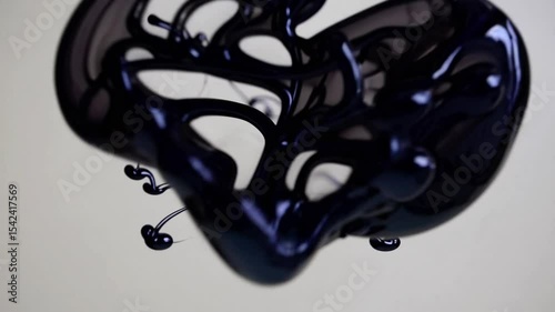 Swirl of black ink mixes clear water in glass. Fluid motion shapes textures. Creativity transformation. Liquid form. Experiment with paint and liquid. White background.