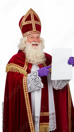 Sinterklaas, Dutch Saint Nicholas dressed in bishops red robe and decorative hat, pointing at blank white papier, placard. Celebration concept for children european party day five december.
