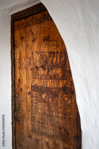 Carved wooden door with nautical motifs in a fishing village on the Mediterranean Sea