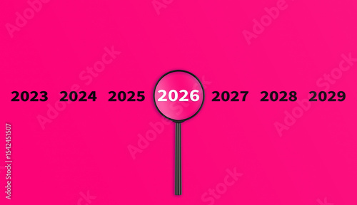 Lens, magnifying glass focusing on the year 2026 on a Pink background. Financial or stock market strategies and past and future events.