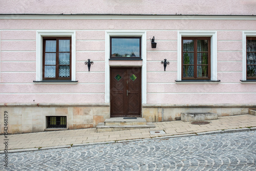 Facade of a old building with modern doors. Designer entrance door to a country house. Modern design. Luxurious exterior.