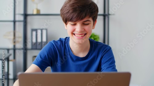 Cheerful teen interacting and giving thumbs up in modern home office setting