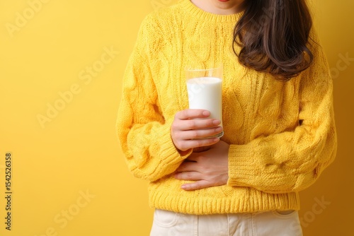 Woman with stomach pain holding milk indicating lactose intolerance