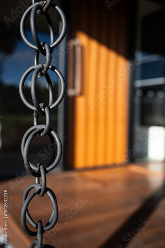close up of chain in front of house