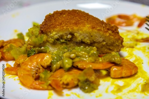 Traditional Bahian acarajé fried in palm oil, of African origin prepared with black-eyed peas, vatapá, caruru, dried and salted shrimp, salad, pepper sauce
