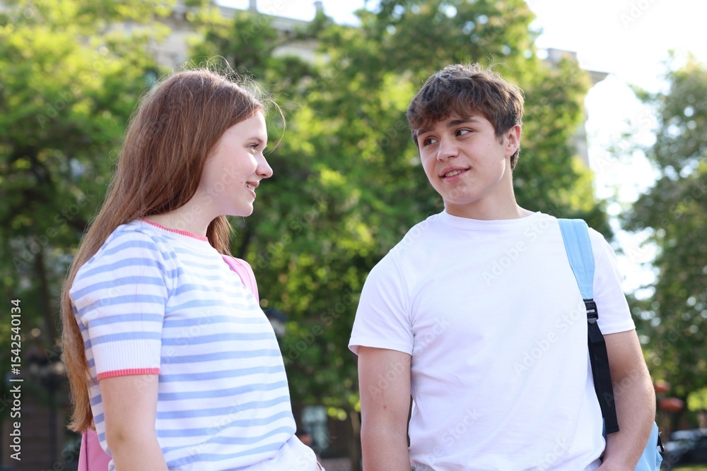 Teenage girl and boy walking together outdoors Teenage girl and boy walking together outdoors