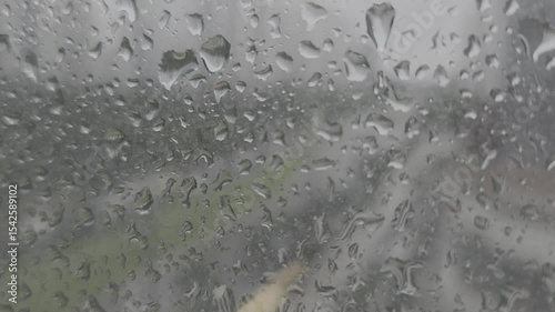 Rainy day cars outside the window and raindrops on the glass.

