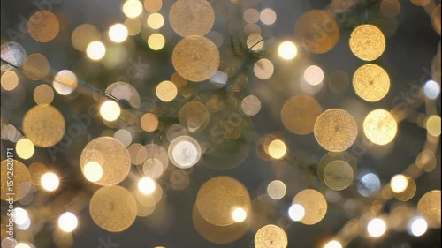 Enchanting golden bokeh lights create a warm, sparkling, abstract festive Christmas background.