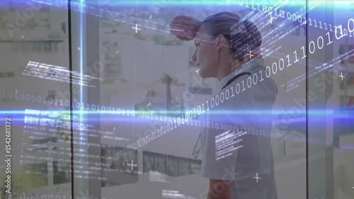 Nurse shielding eyes at window upon binary code and blue light bars drifting, scanning medical data
