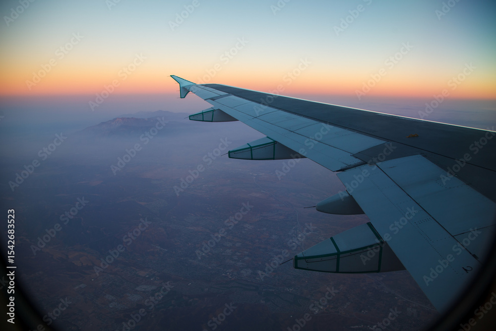 Obraz premium Beautiful Sunset over Los Angeles, Californita, United States on a flight with the airplane wing.