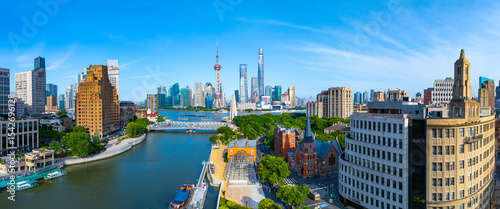 Panoramic Aerial view of Shanghai skyline and winding river on sunny day.