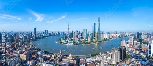 Panoramic Aerial view of Shanghai skyline and winding river on sunny day.