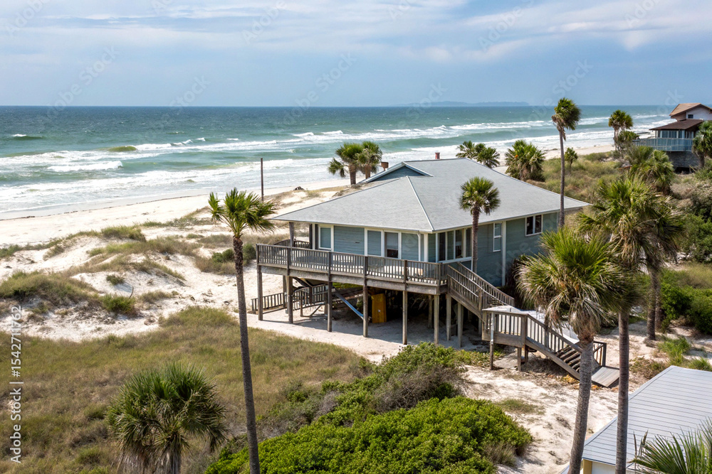 Fototapeta premium Secluded beach house retreat with serene coastal views and ocean breezes