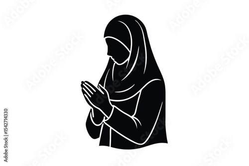 Young woman in hijab praying outdoors