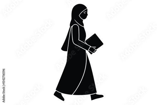 Young woman in hijab walking and holding a quran
