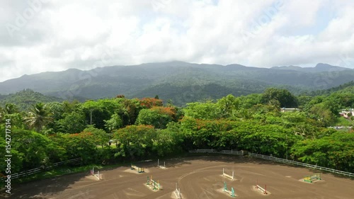 Aerial view of a horse arena surrounded by lush greenery and mountains on a sunny day, Puerto Rico photo