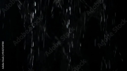 Raindrops Falling: A Dynamic Display of Water Cascading Down in a Dark Environment