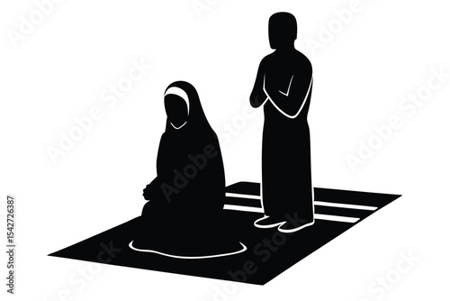 Silhouette of muslim couple praying on prayer mat