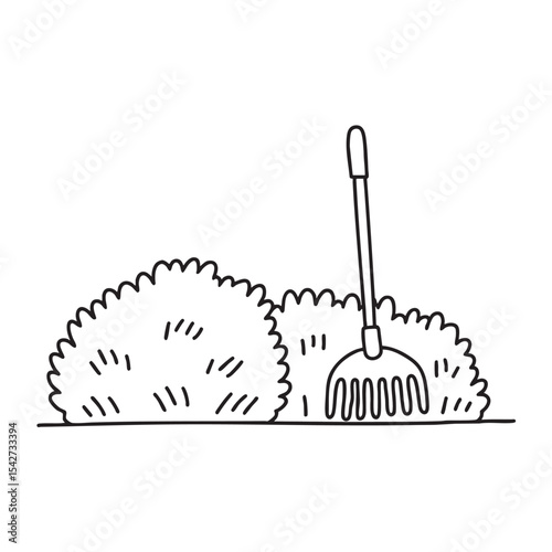 A rake propped beside thick backyard underbrush