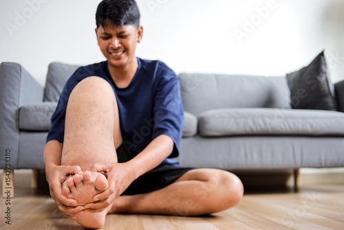 Close Up Of Leg Afflicted With Elephantiasis With The Person Trying To Alleviate Discomfort