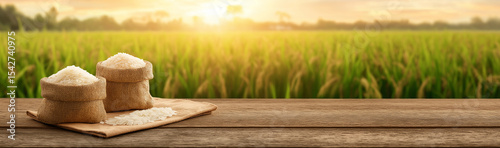 A wide - banner scene, with pastoral rice fields as the background, bamboo containers with rice on a wooden table, full of a rustic atmosphere.