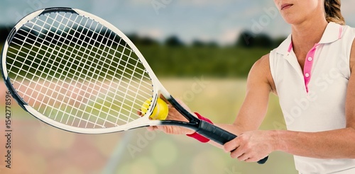 Midsection of sportswoman holding racket