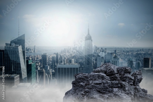 Large rock overlooking big city
