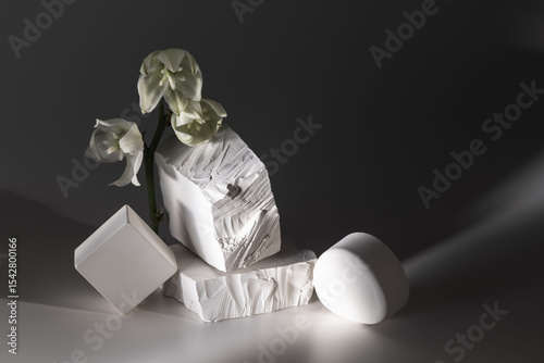 Still life with plaster figures and yucca flowers.