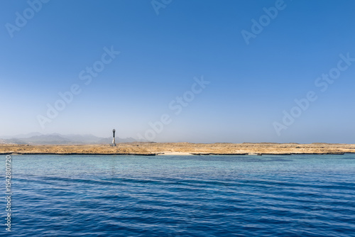 A lighthouse on a rocky beach in the Gulf of Aqaba off the deserted shores of Ras Mohamed National Park in South Sinai.