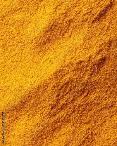 Close-Up View of Ground Turmeric Powder with Visible Texture Details